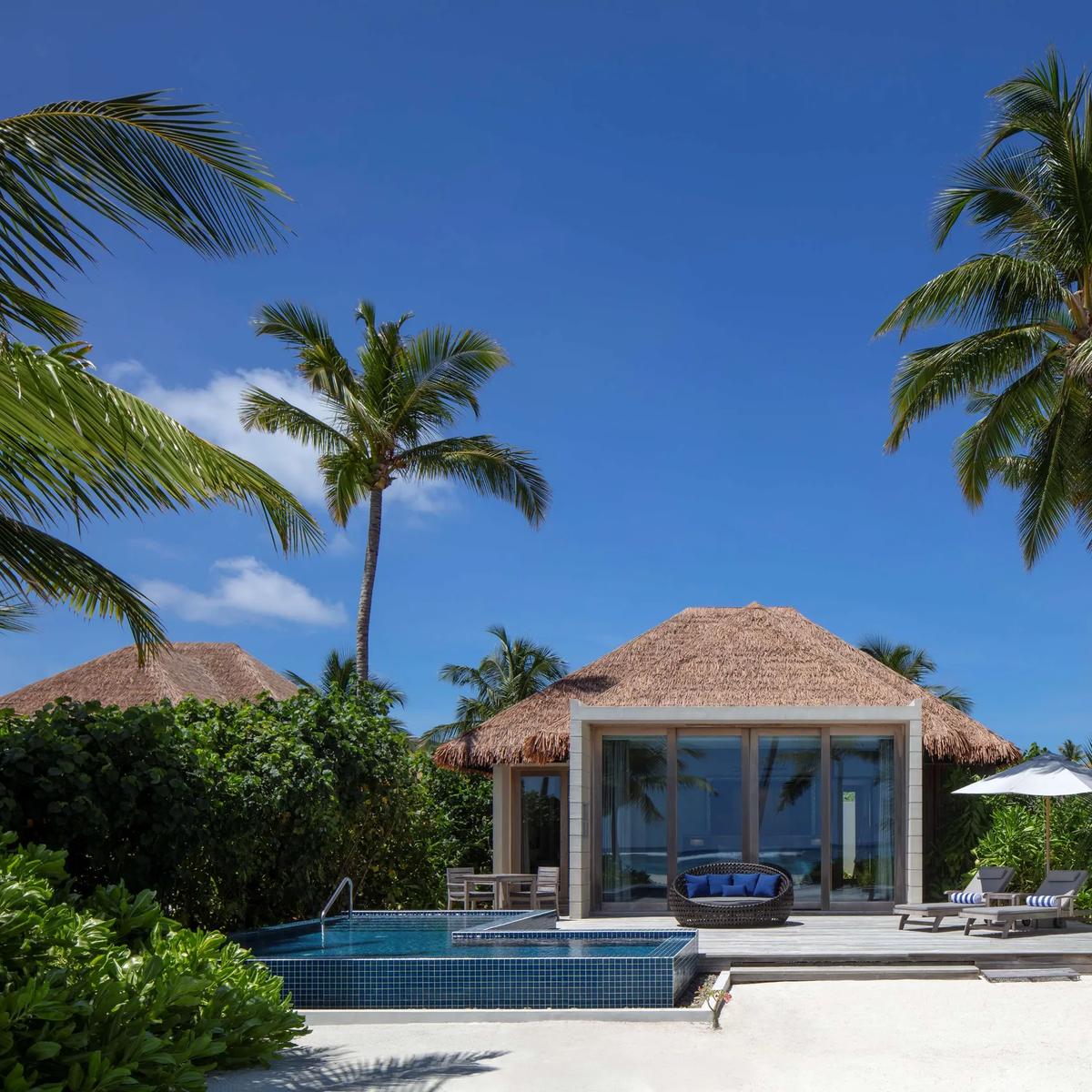 A Beach Villa's private pool and deck at Radisson Blu Resort Maldives among palm trees; a dedicated photograph of In-Villa Dining was not available in this research pool, so this villa deck setting stands in as a reference