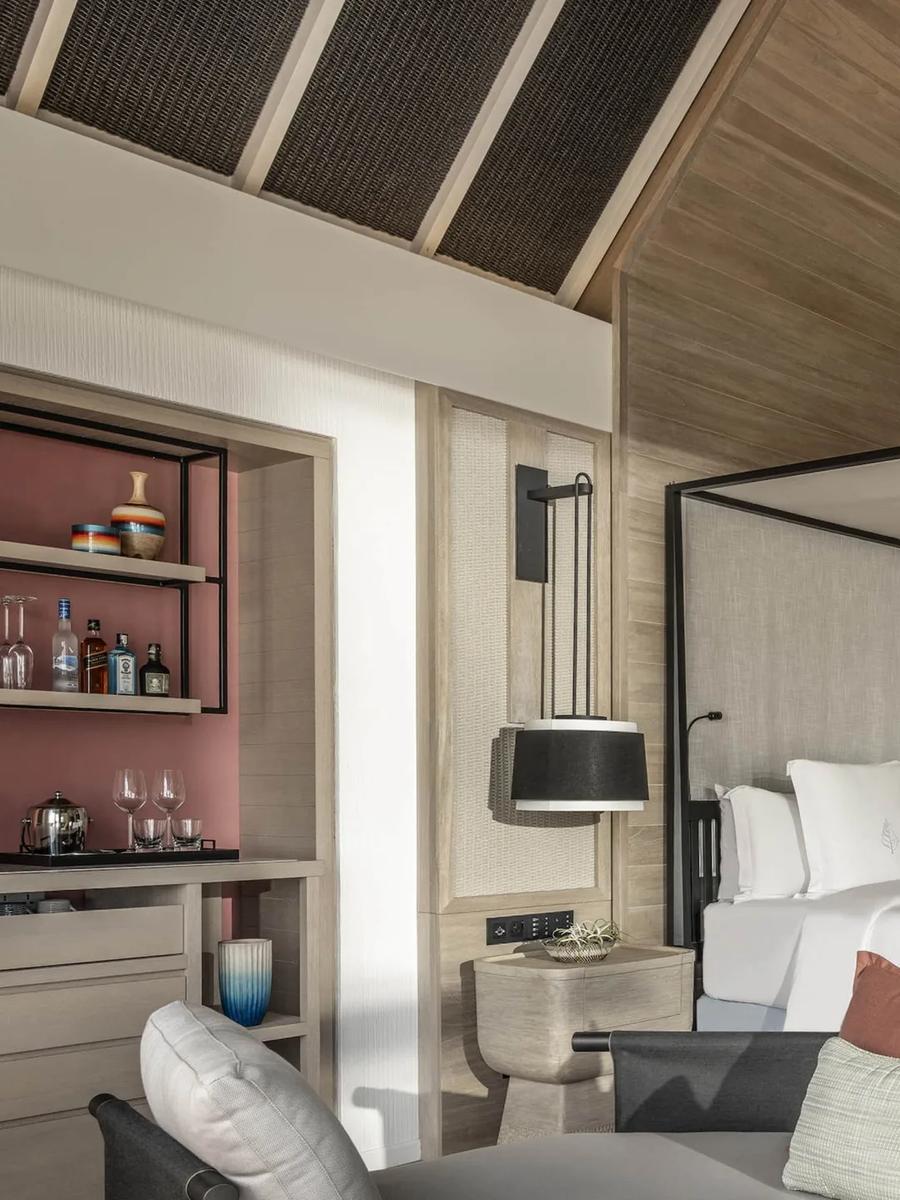 The four-poster bed and private bar nook inside a Two-Bedroom Oceanfront Bungalow with Partial Sea View