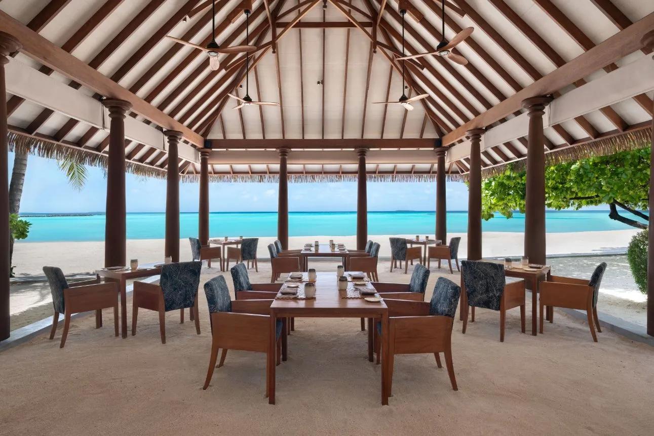 Ranba's open-air, beachfront dining room at Heritance Aarah, tables set facing the lagoon