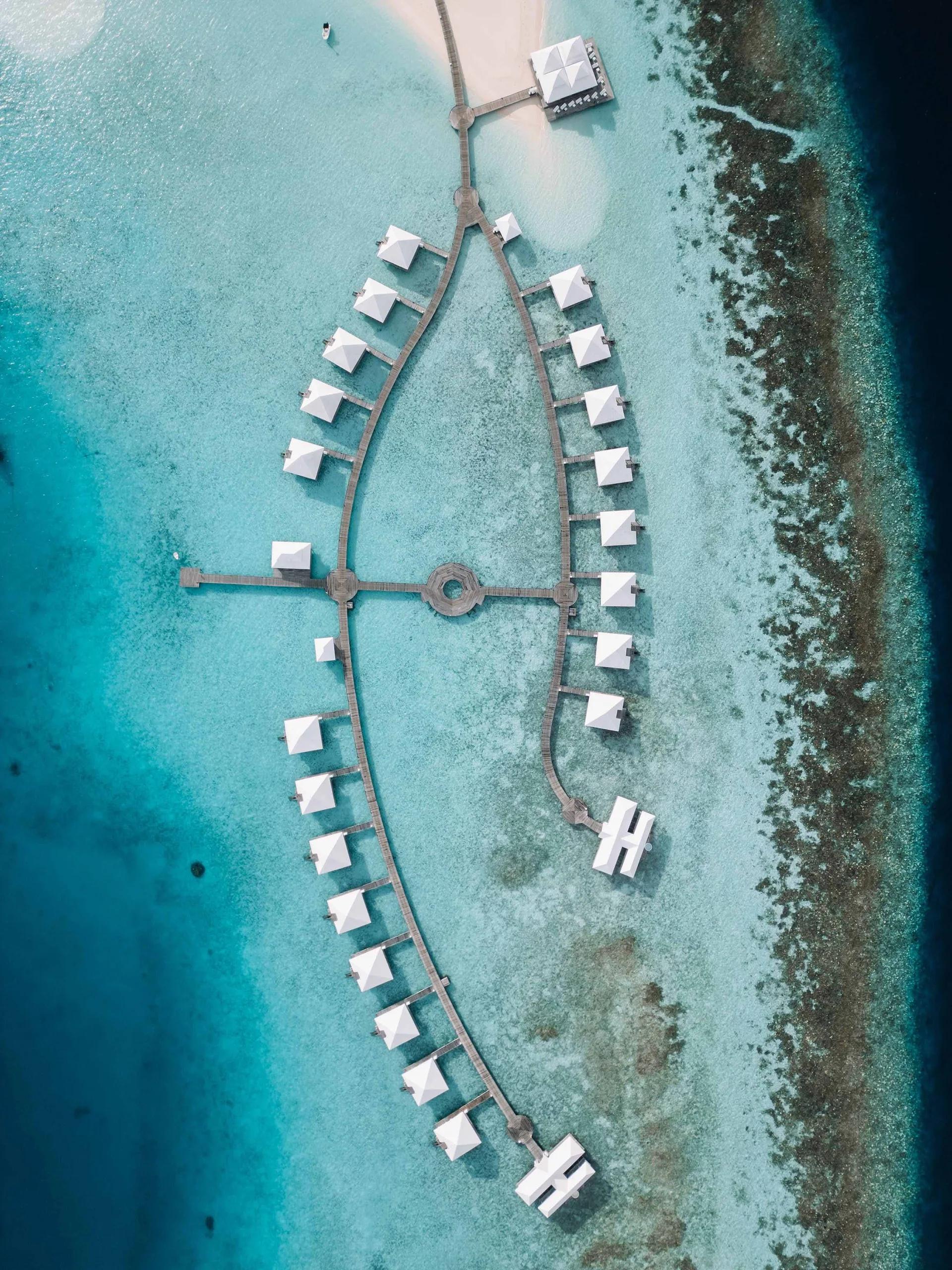 Aerial view of Diamonds Athuruga's water villa jetties, arranged in a Y over the lagoon