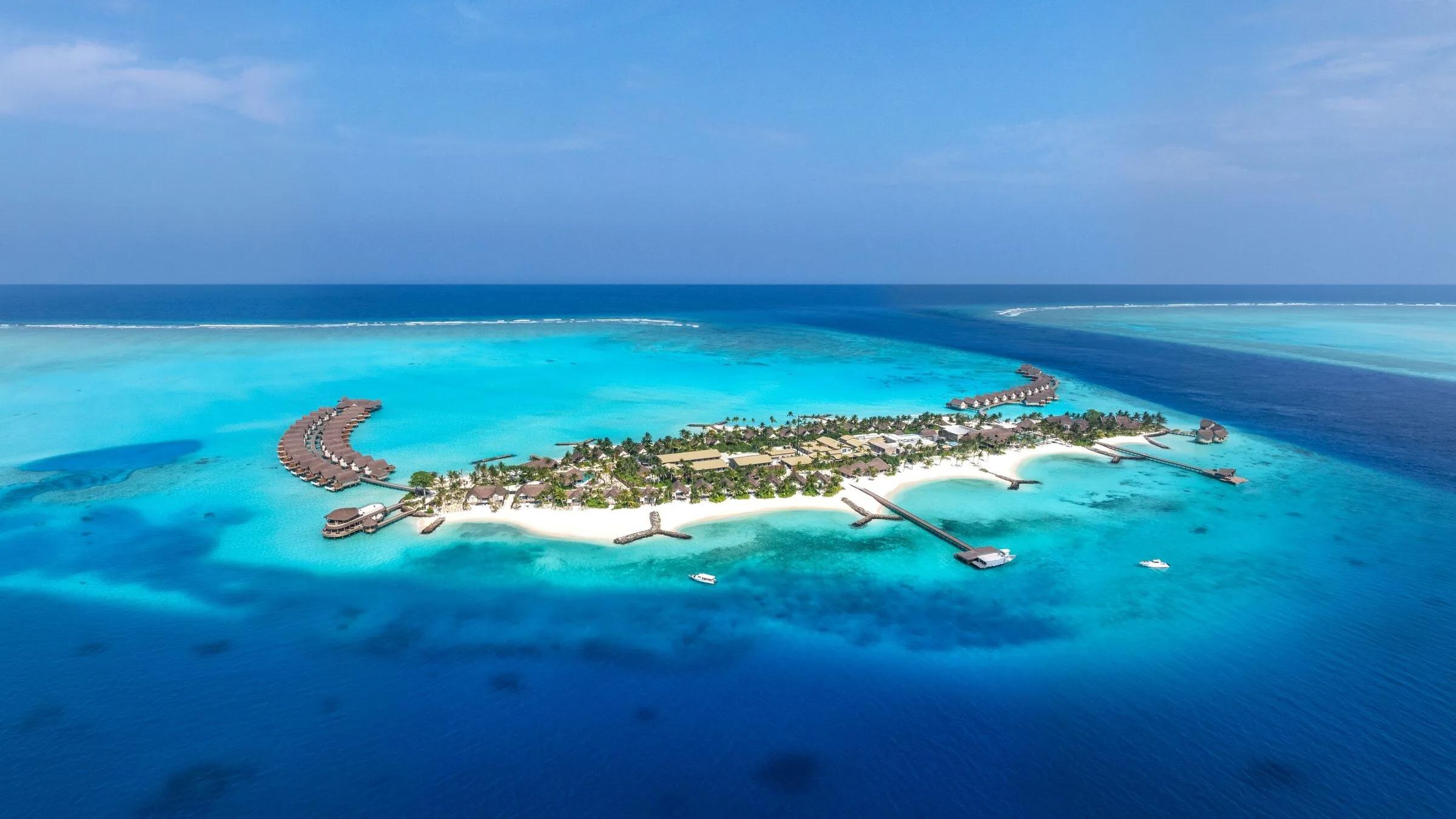 An aerial view of JW Marriott Maldives Kaafu Atoll's private island set within Kaafu Atoll's largest lagoon