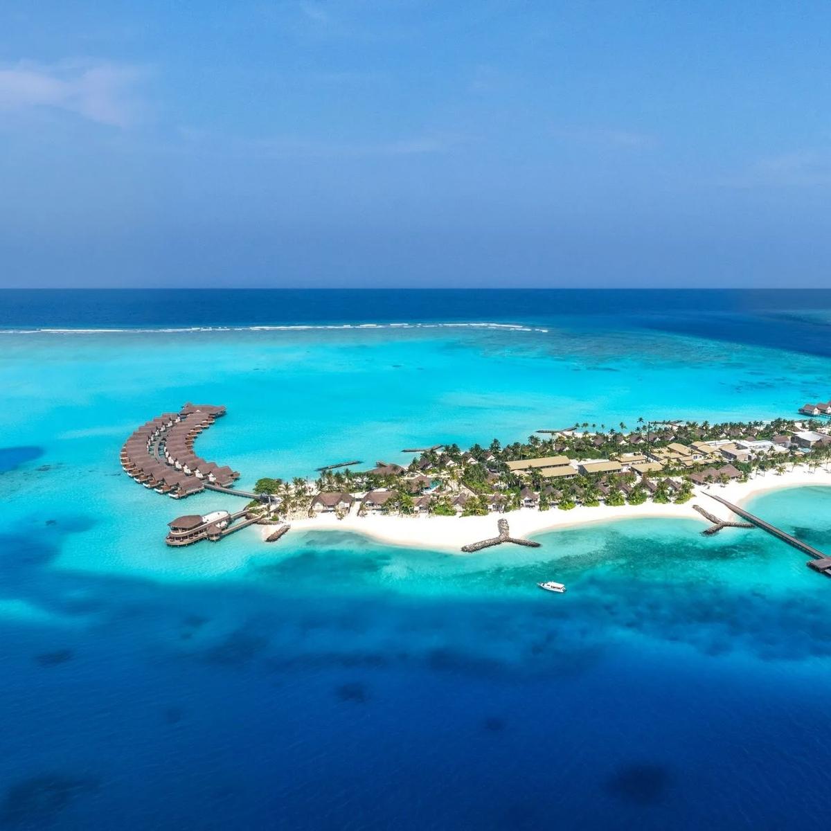 An aerial view of JW Marriott Maldives Kaafu Atoll's private island set within Kaafu Atoll's largest lagoon