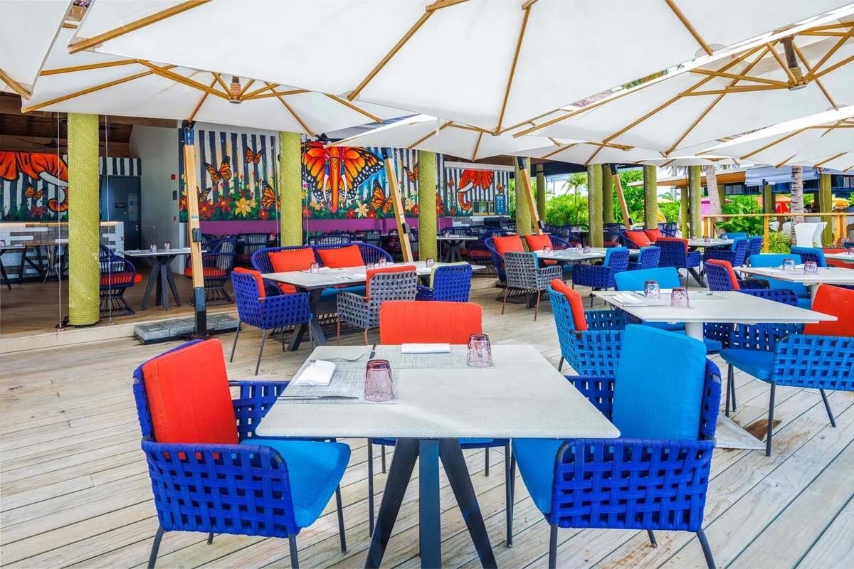 The Elephant and The Butterfly's covered terrace seating, its namesake mural of an elephant and monarch butterflies painted on the wall behind