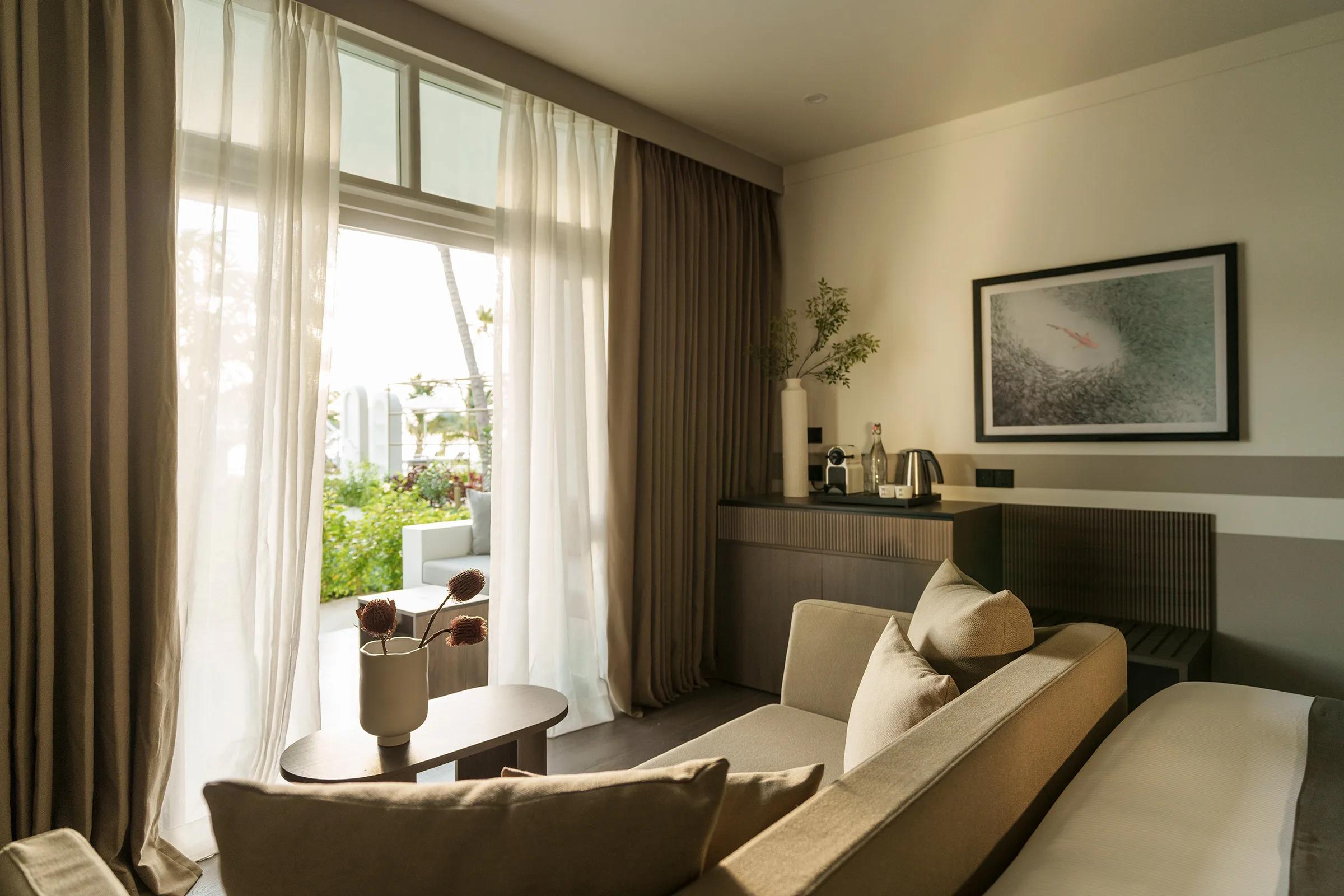 View from a Sunset Beach Pavilion bedroom toward the beach at Sun Siyam Olhuveli