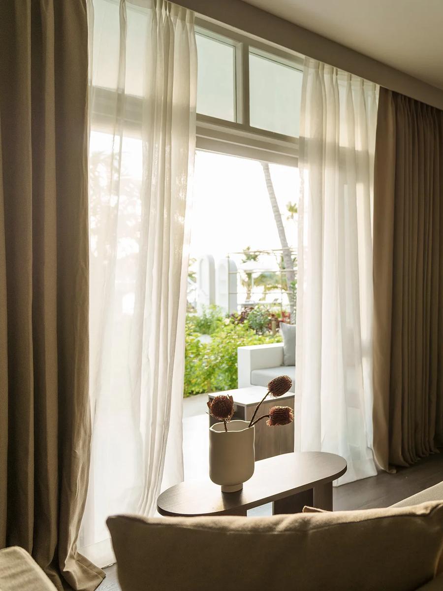 View from a Sunset Beach Pavilion bedroom toward the beach at Sun Siyam Olhuveli