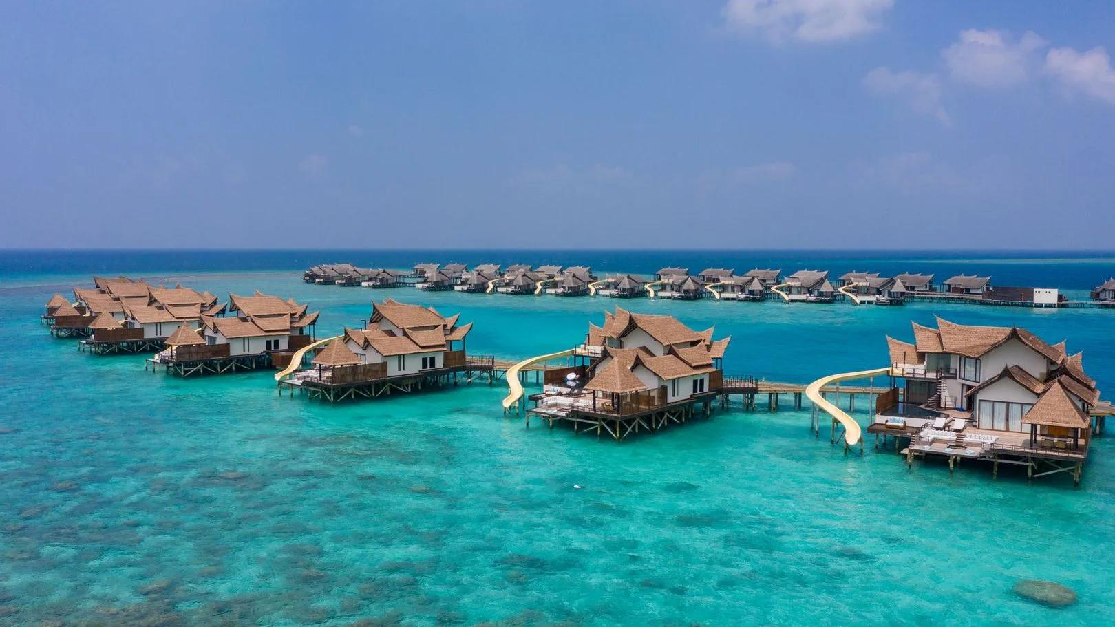 An Ocean Pool RESERVE Sunset with Slide villa's private pool, sun deck and water slide, built on its own jetty over the lagoon