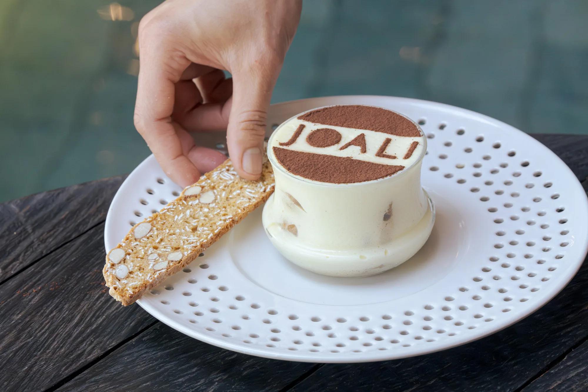 A JOALI-branded dessert plated tableside at Bellinis — Wine Cellar photograph to follow