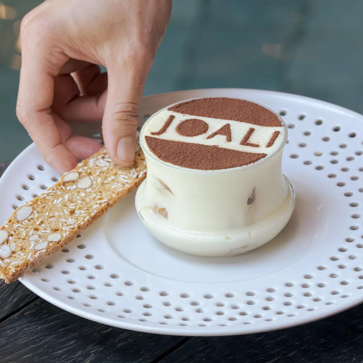 A JOALI-branded dessert plated tableside at Bellinis — Wine Cellar photograph to follow