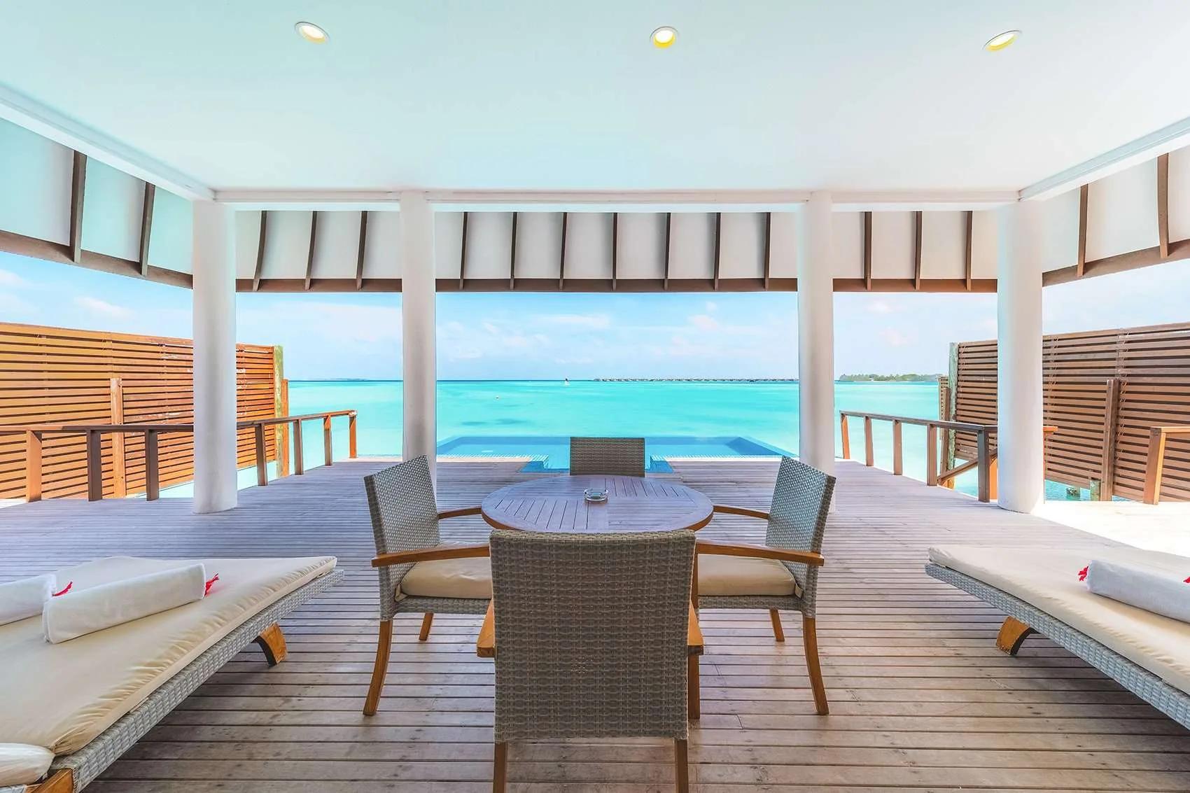 The overwater deck and pool of a Deluxe Water Villa with Pool, lagoon and horizon beyond, Hideaway Beach Resort & Spa