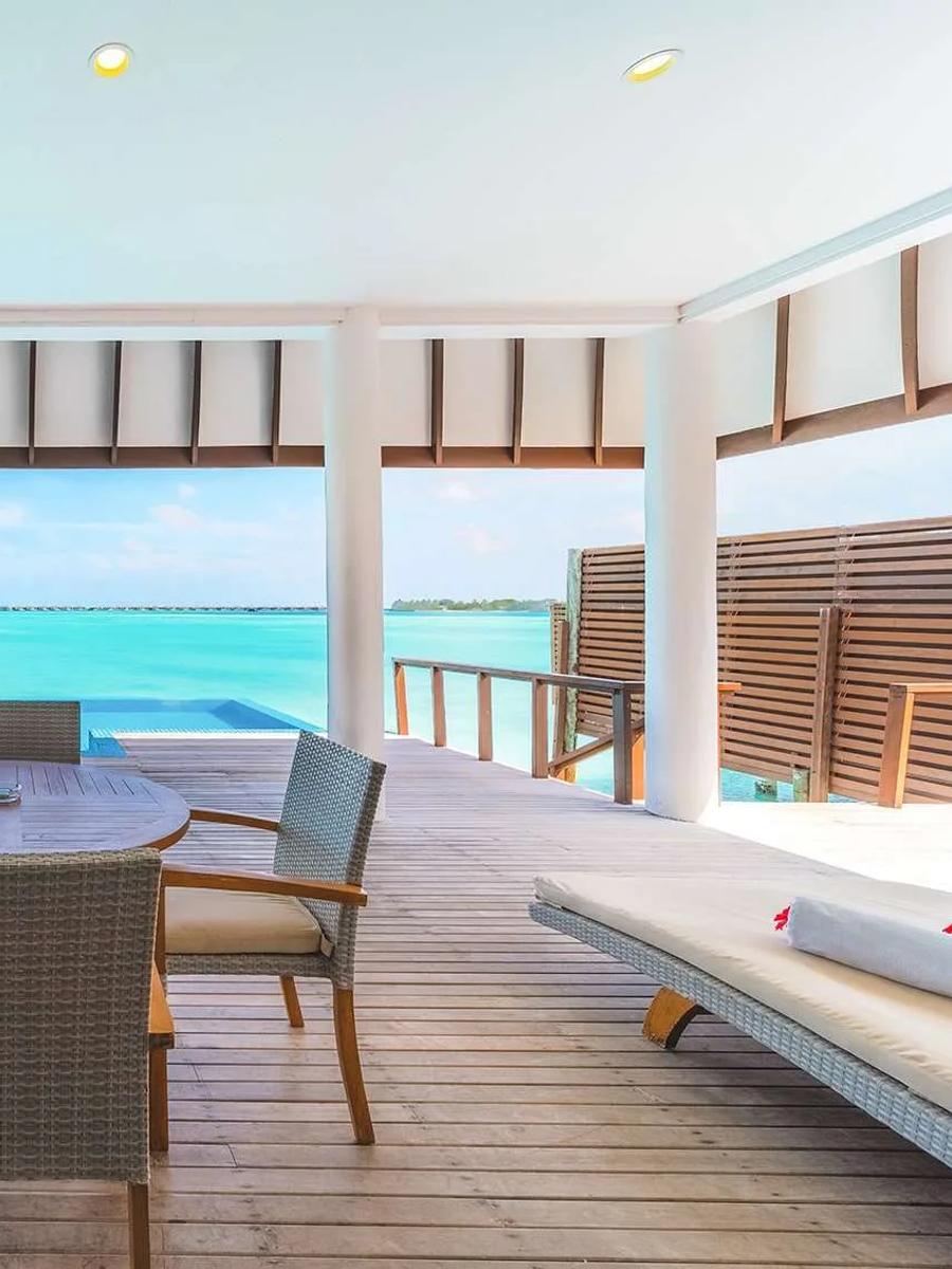 The overwater deck and pool of a Deluxe Water Villa with Pool, lagoon and horizon beyond, Hideaway Beach Resort & Spa