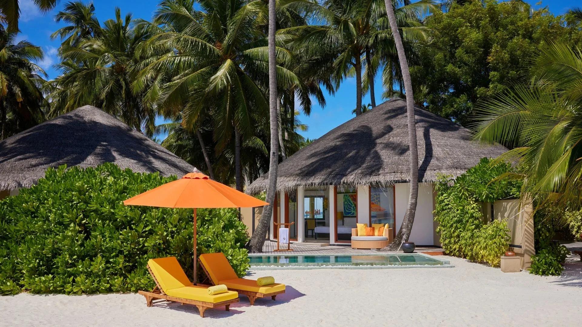 Exterior of a Beachfront Infinity Pool Villa at Angsana Velavaru, its circular hut and pool set back from the beach