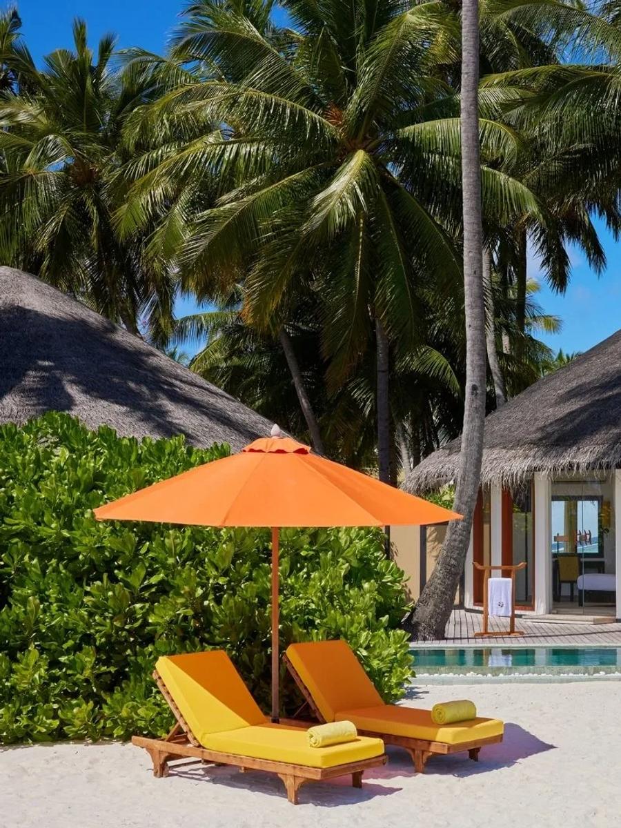 Exterior of a Beachfront Infinity Pool Villa at Angsana Velavaru, its circular hut and pool set back from the beach