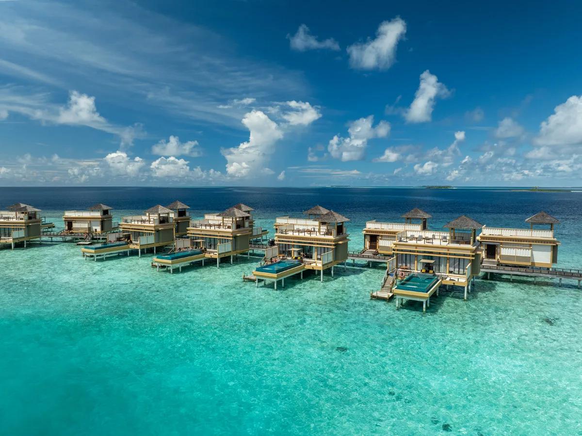 Aerial view of an In-Ocean Pool Villa's reef-edge infinity pool at Angsana Velavaru