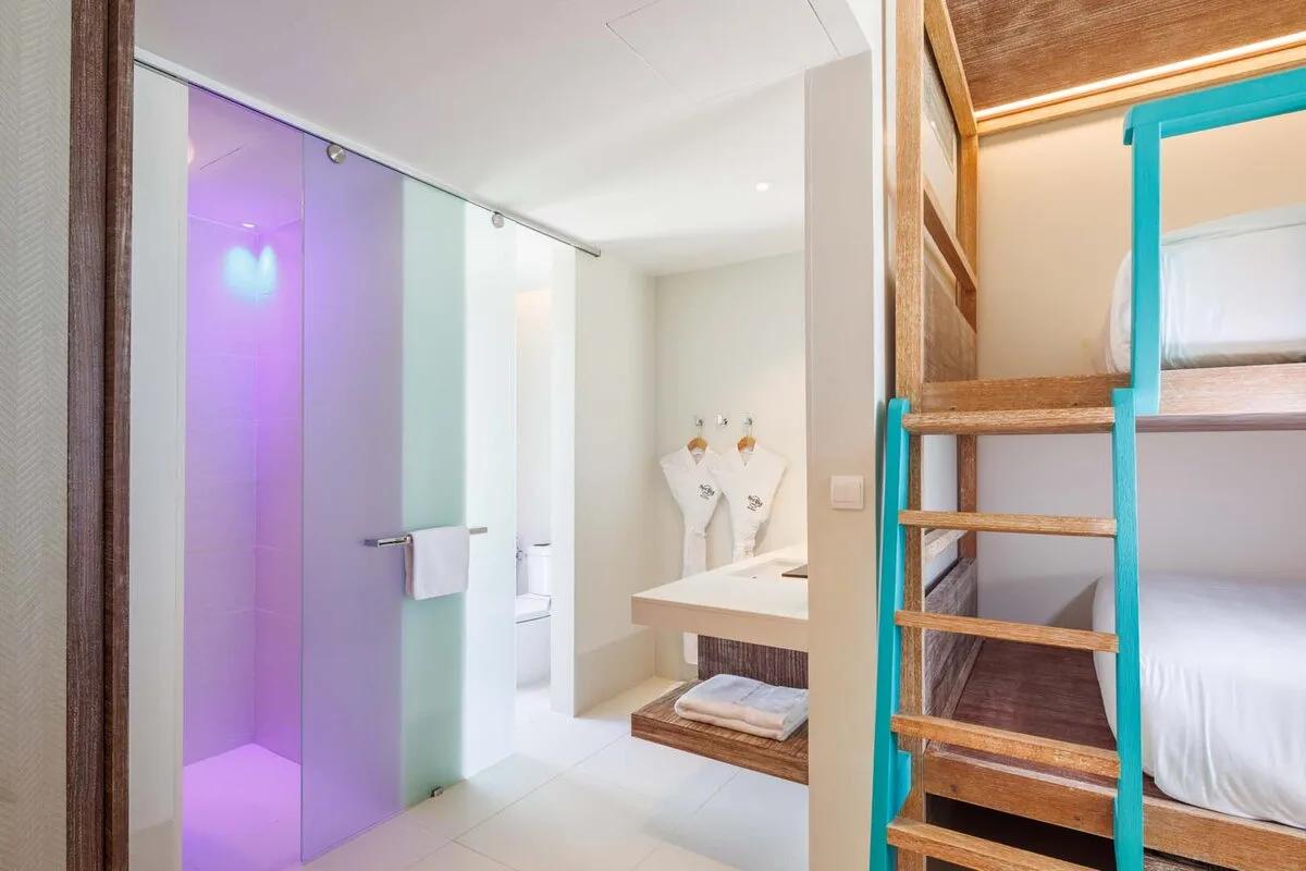 A Silver Family Suite's bathroom, its bunk bedroom visible alongside through the doorway