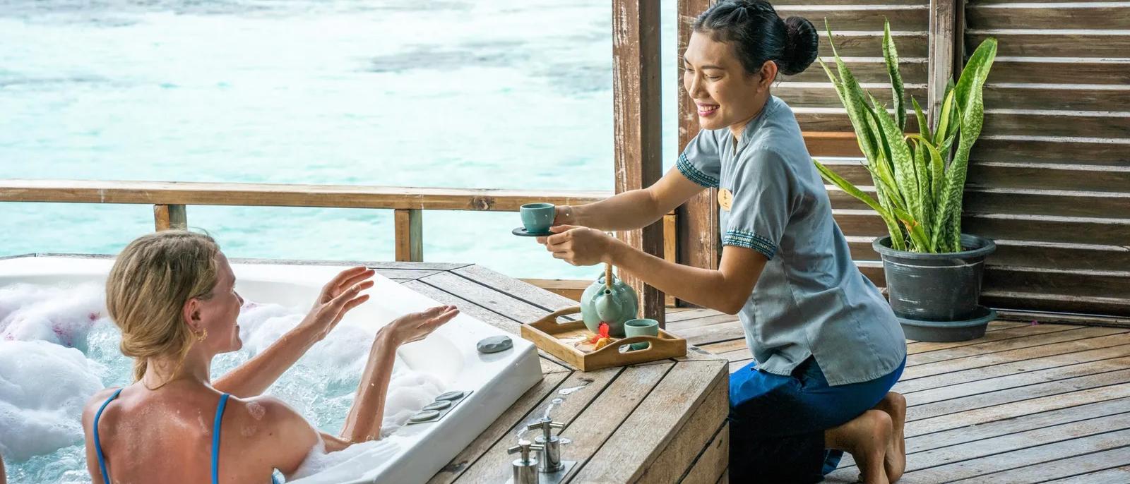 Overwater yoga deck and spa at a Maldives wellness resort