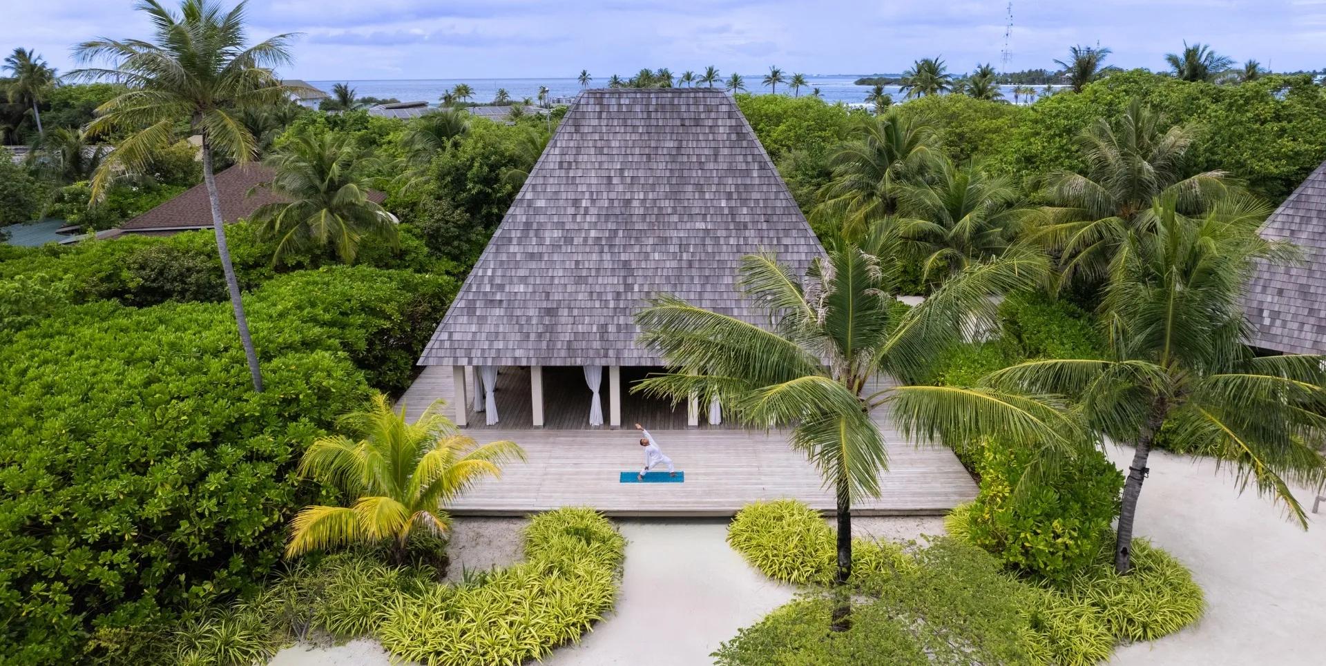 A yoga session on Kuda Villingili's elevated wellness pavilion