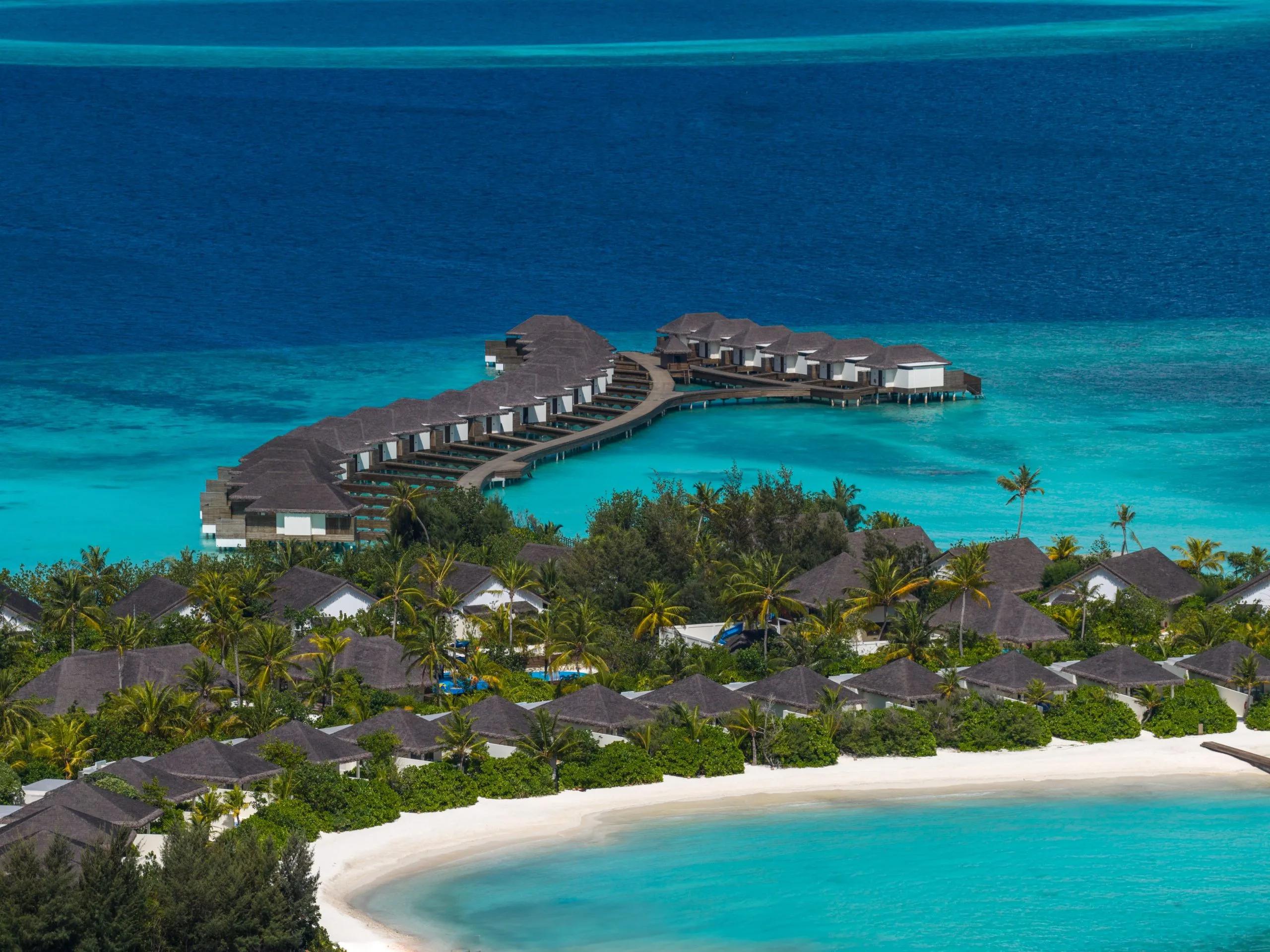 An aerial view of dusitD2 Feydhoo Maldives and its lagoon in North Malé Atoll