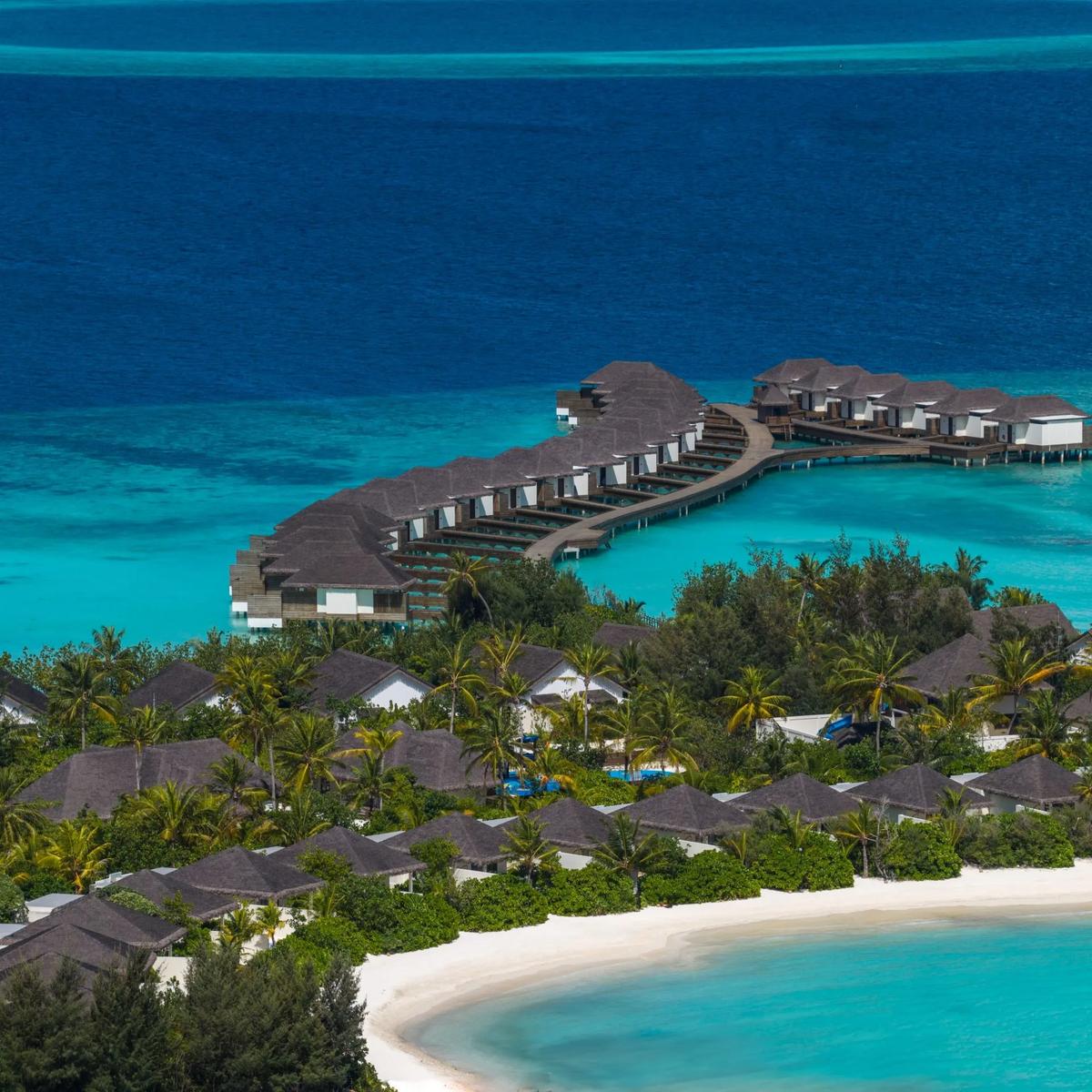An aerial view of dusitD2 Feydhoo Maldives and its lagoon in North Malé Atoll