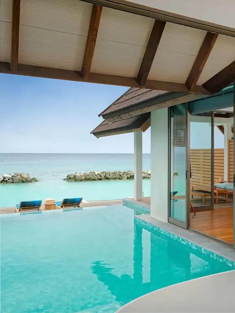 A Semi-Ocean Pool Suite's bedroom and terrace, the resort's only villa image below 1200px at source