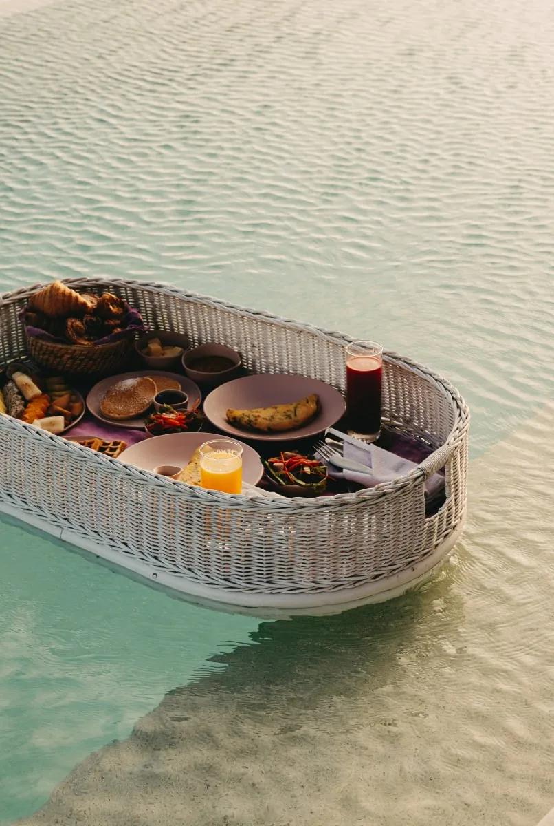 A floating breakfast tray set adrift in a villa pool at Soneva Jani