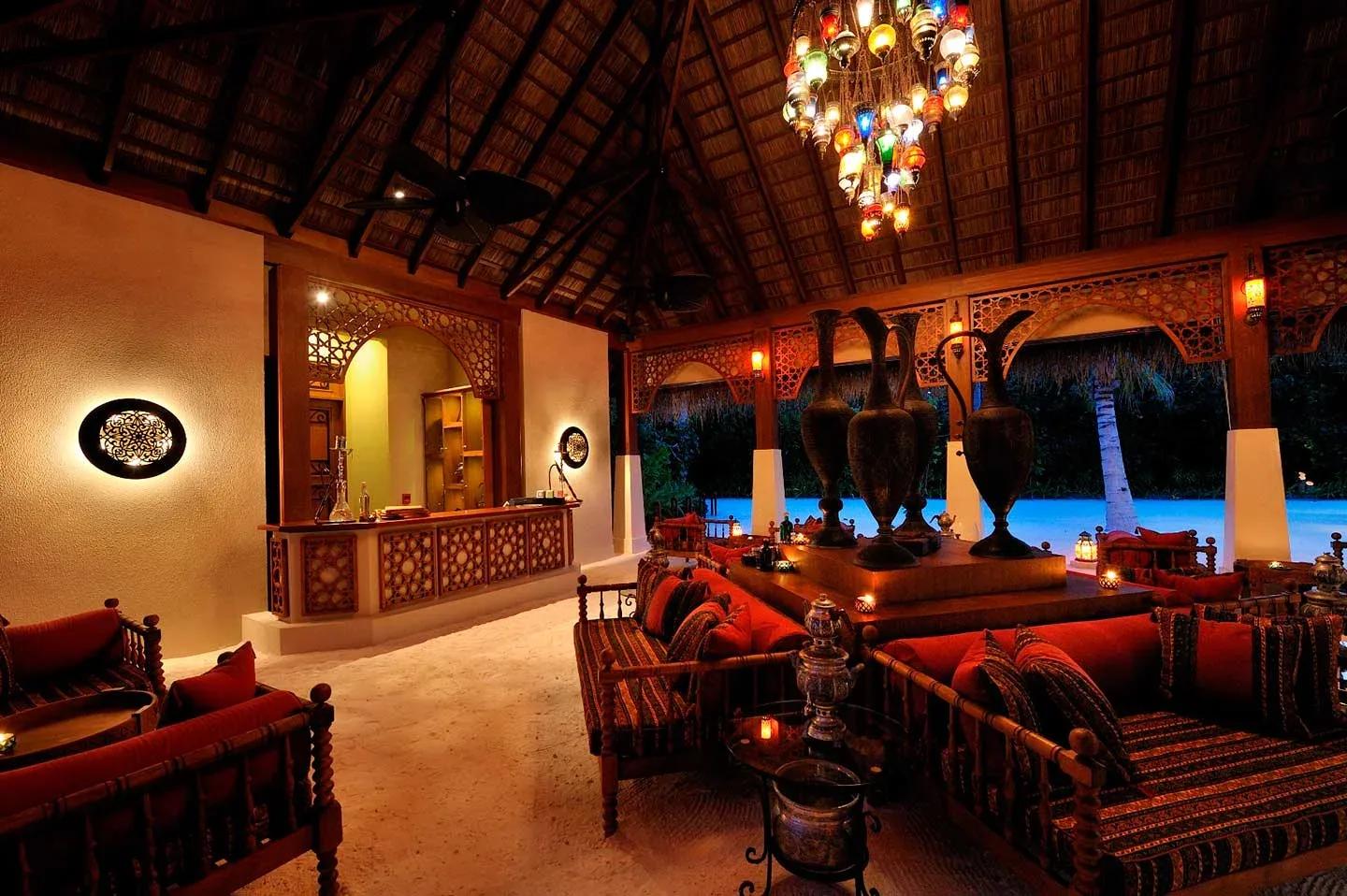 Ottoman Lounge's low seating and filigree glass chandelier, in the traditional Turkish style