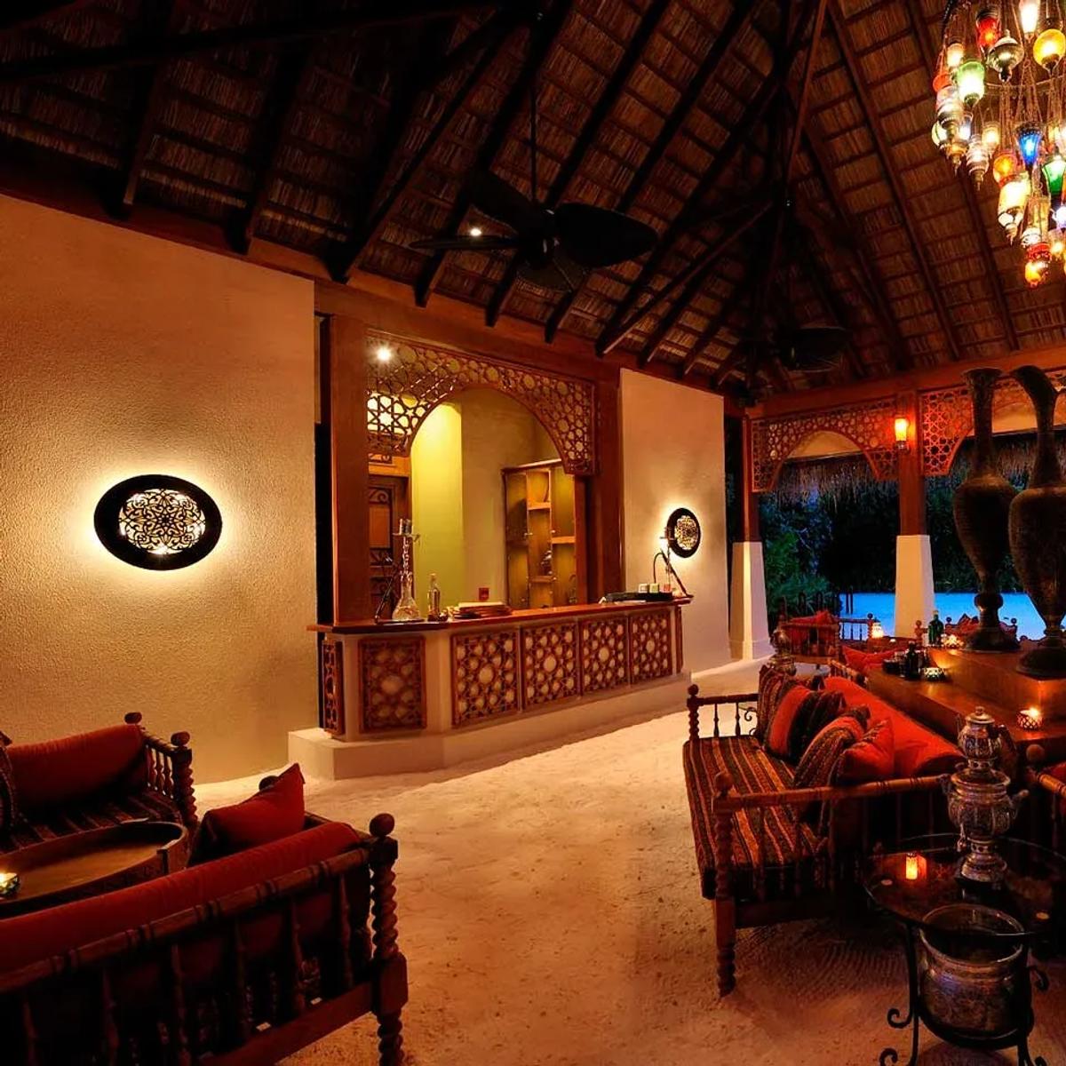 Ottoman Lounge's low seating and filigree glass chandelier, in the traditional Turkish style