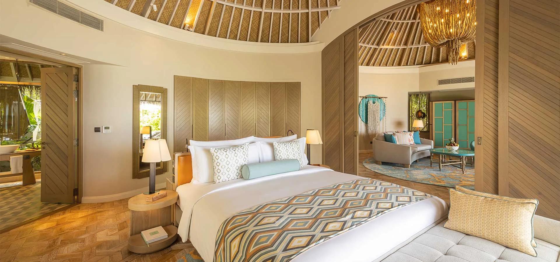 A Beach House bedroom in warm wood tones, its adjoining sitting room built around a sunken plunge pool.