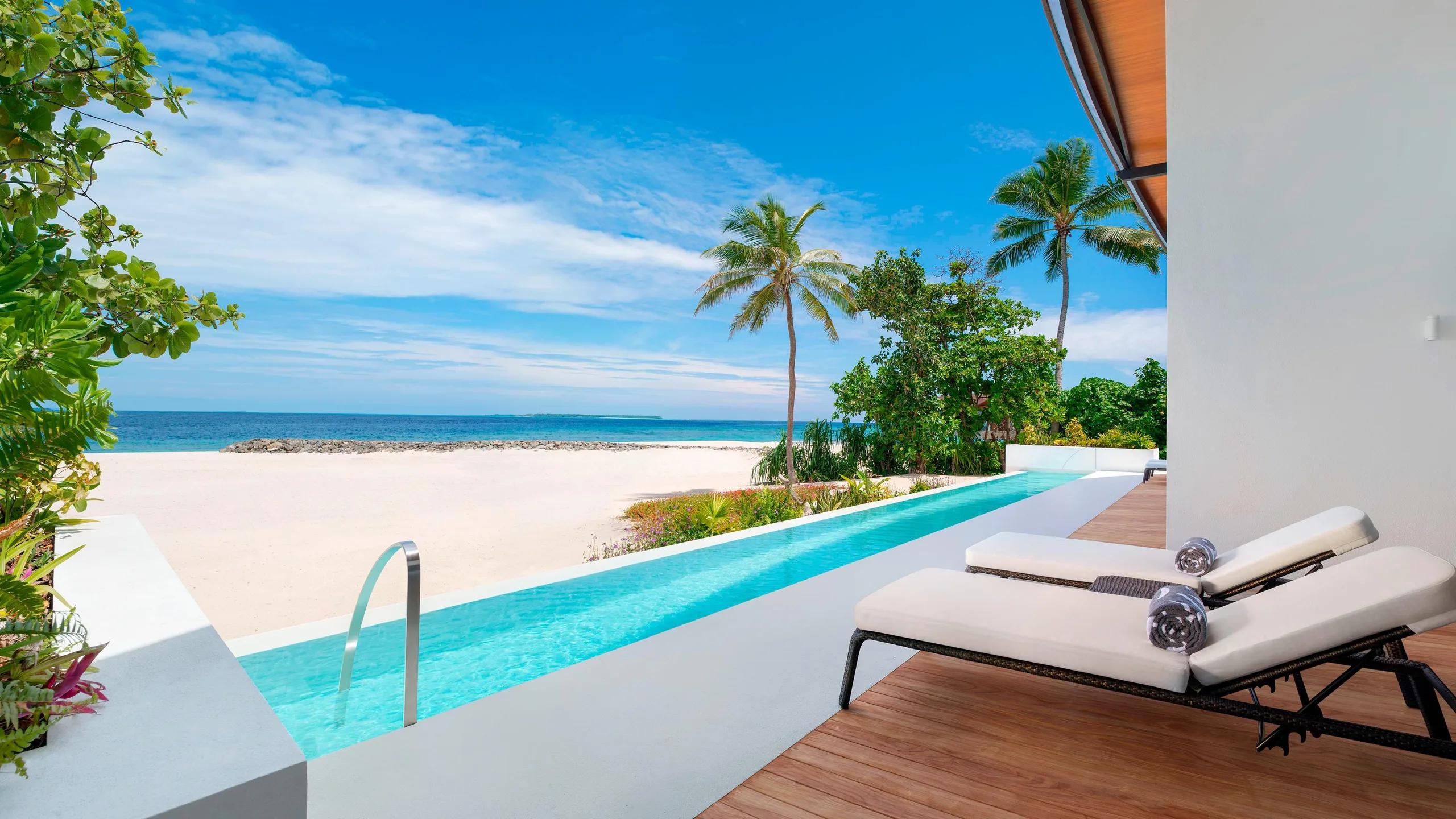 The long lap pool of a Heavenly Beach Residence, running beside the beach toward the lagoon
