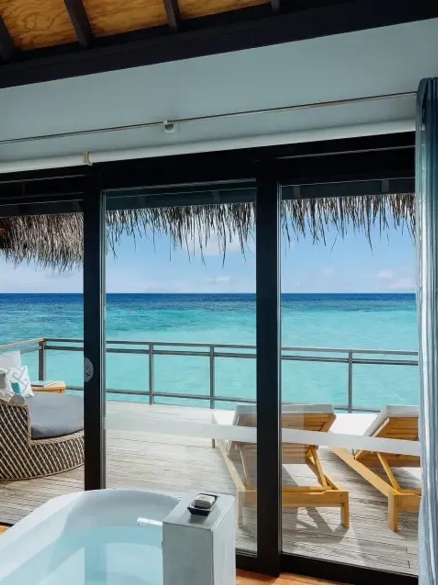 Water Villa's overwater deck and open ocean view, with steps down toward the lagoon