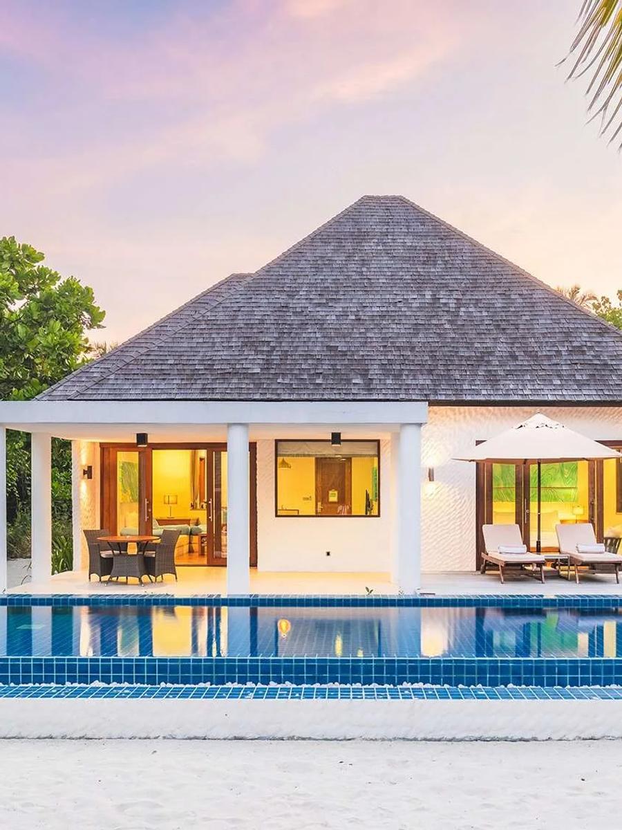 A Deluxe Beach Residence with Lap Pool at twilight, its rectangular lap pool lit blue, Hideaway Beach Resort & Spa
