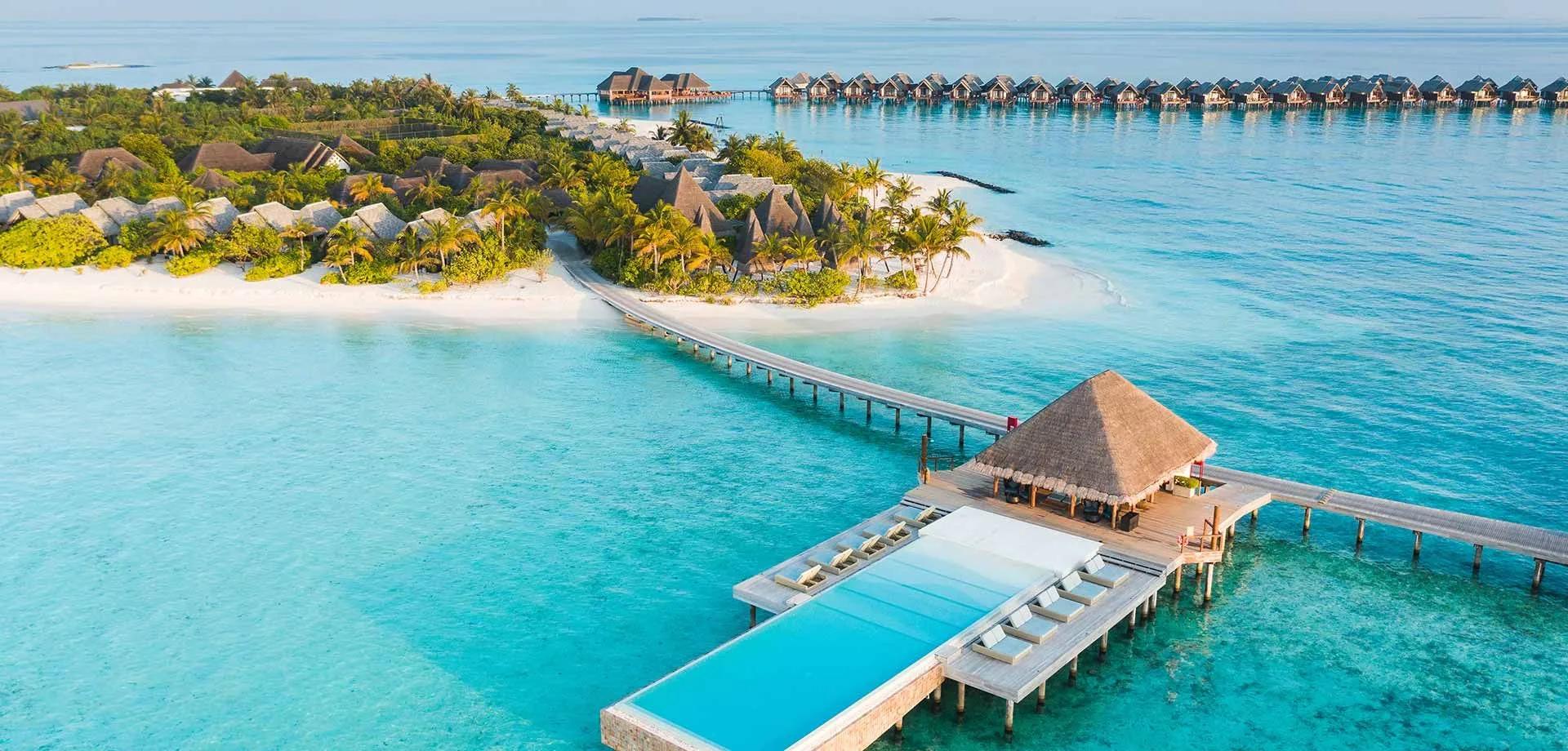 Aerial view of Heritance Aarah's island, jetty and overwater villas