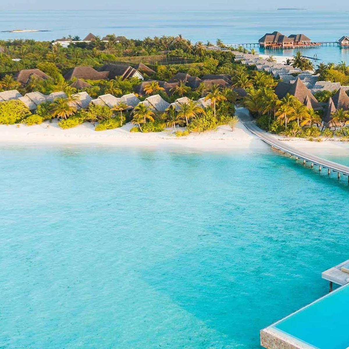Aerial view of Heritance Aarah's island, jetty and overwater villas