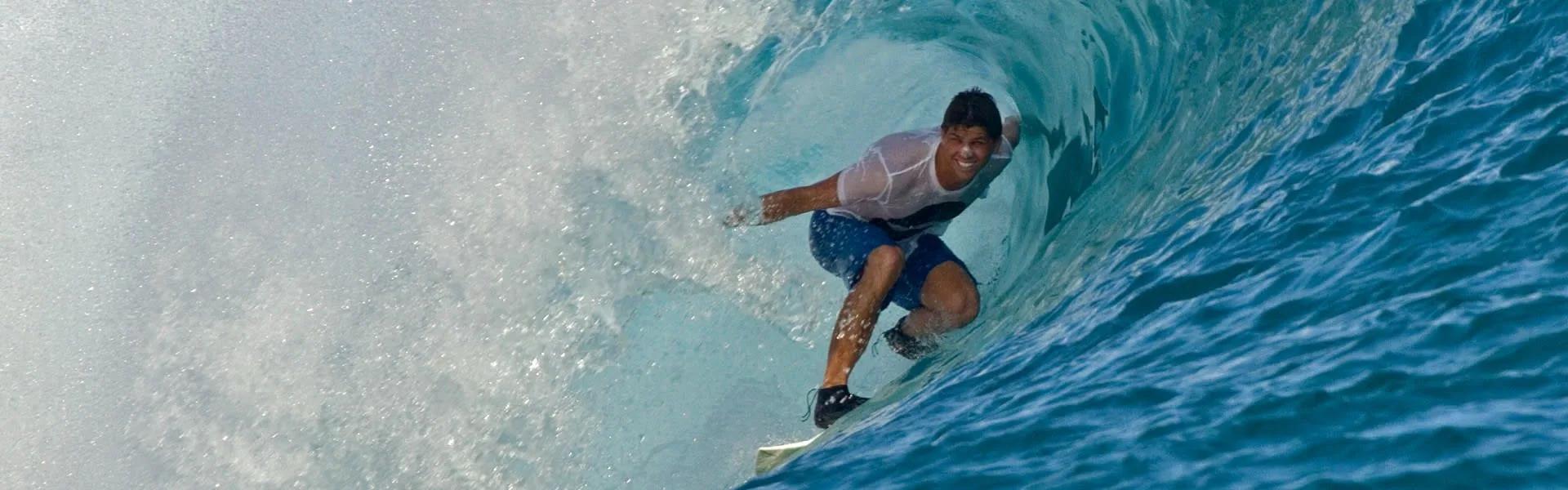 A surfer riding inside the barrel of a wave near Anantara Veli