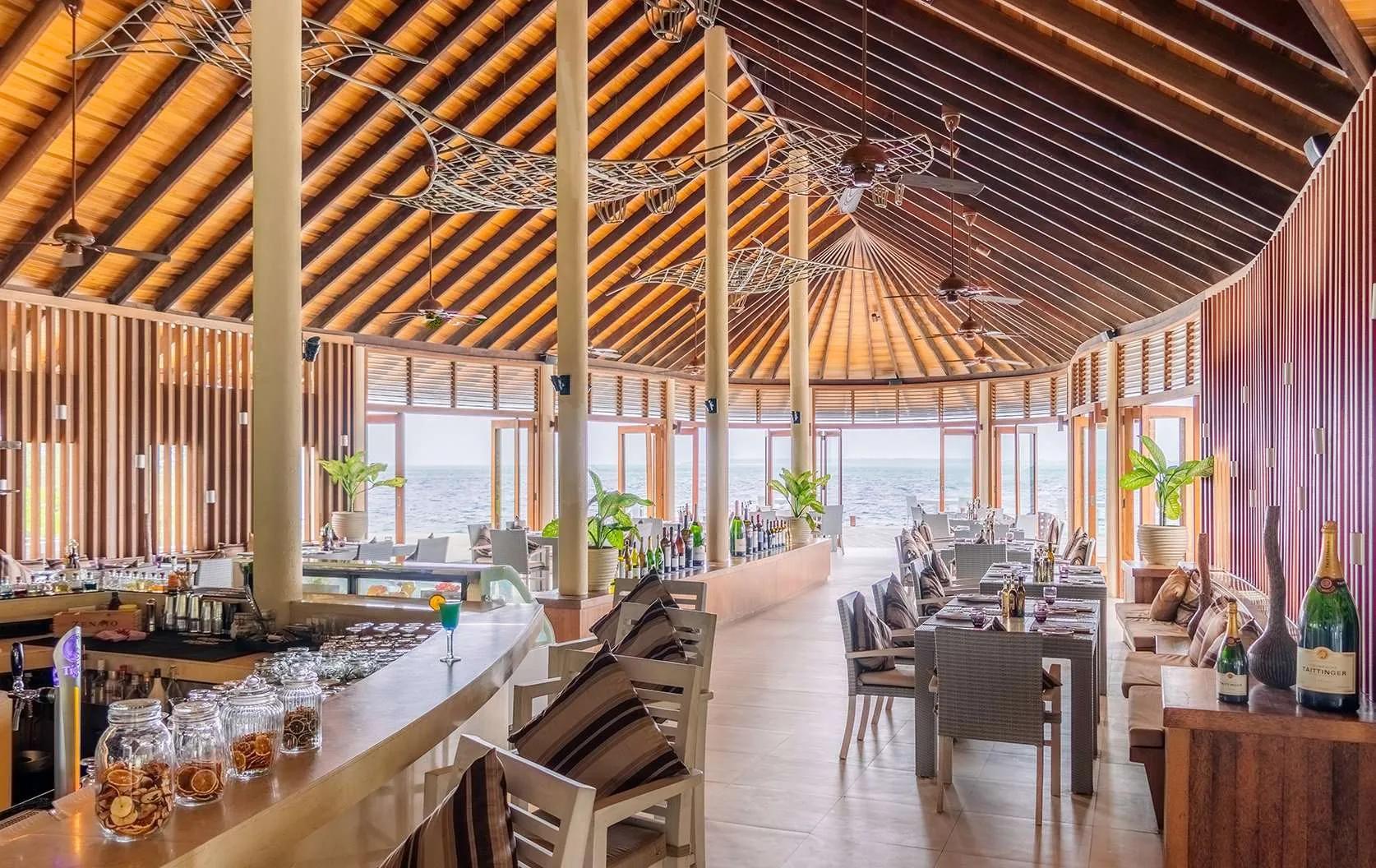 Interior of Meeru Bar & Grill, wood-fired grill and fish sculptures overhead