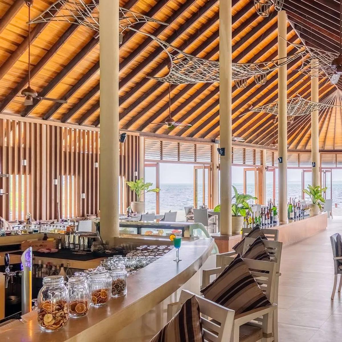 Interior of Meeru Bar & Grill, wood-fired grill and fish sculptures overhead