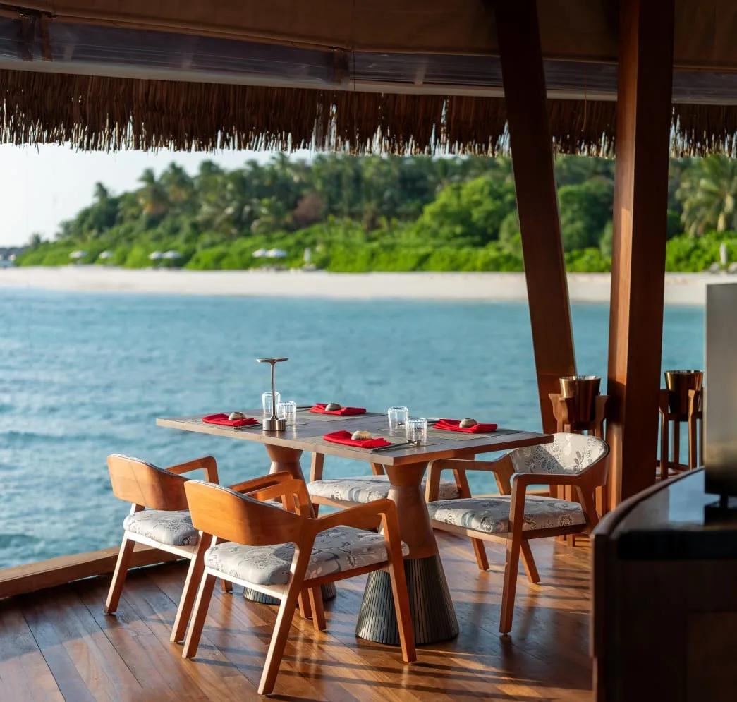 Overwater seating at FIRE restaurant, Anantara Kihavah Maldives Villas