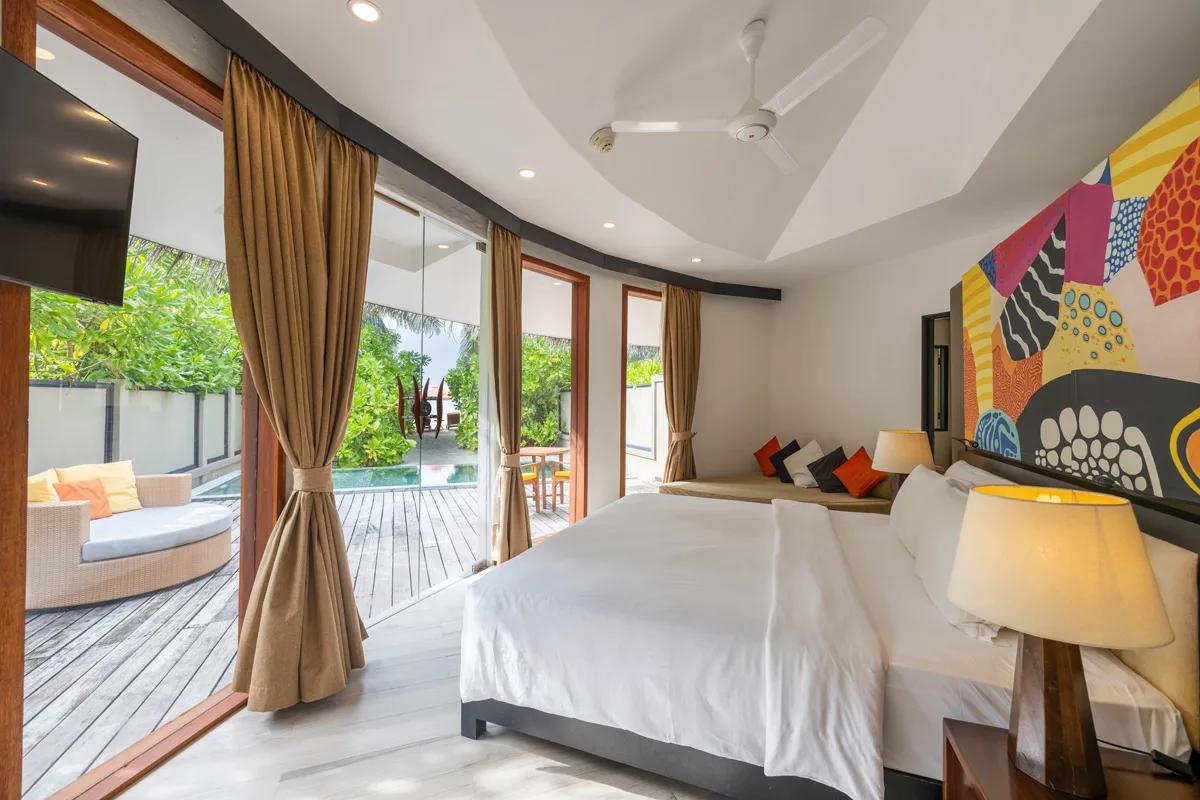 Exterior of a Beachfront Family Pool Villa at Angsana Velavaru, its two huts and shared garden