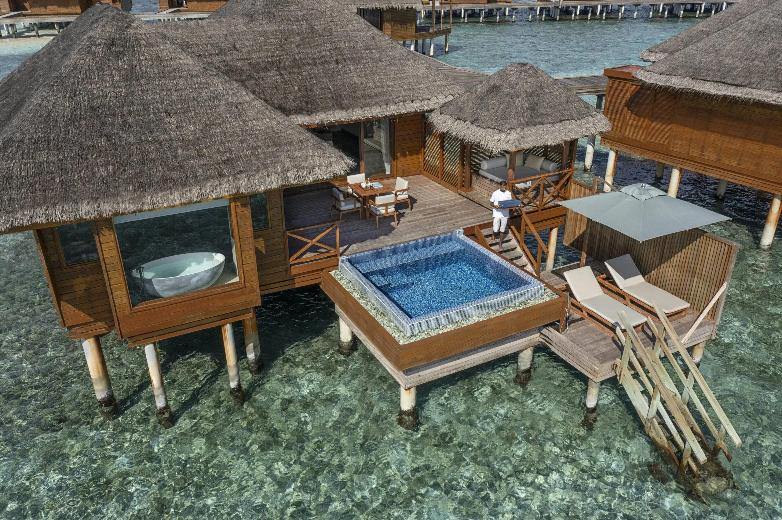 Aerial view of a Lagoon Bungalow with Pool, its square plunge pool and freestanding bathtub visible on the overwater deck