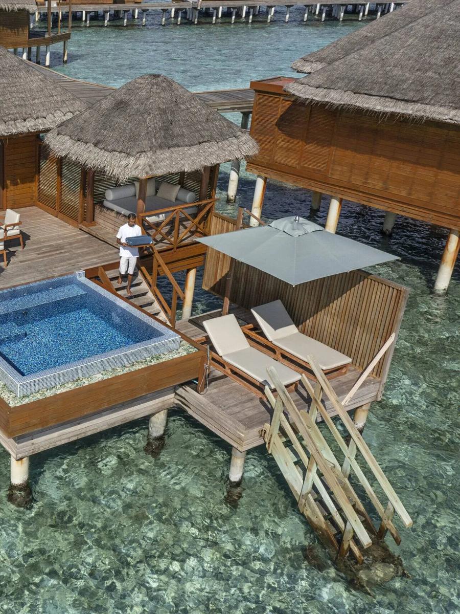 Aerial view of a Lagoon Bungalow with Pool, its square plunge pool and freestanding bathtub visible on the overwater deck