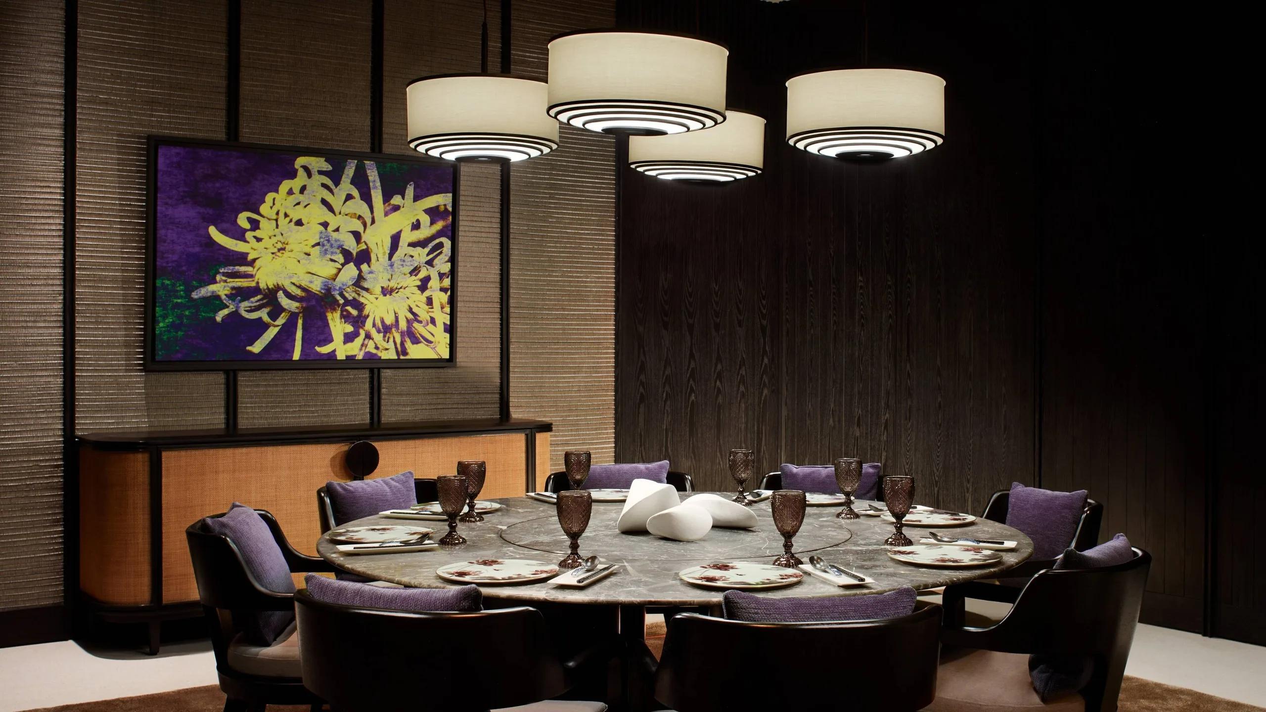 Summer Pavilion's private round dining room, lantern-style pendant lights above a marble table