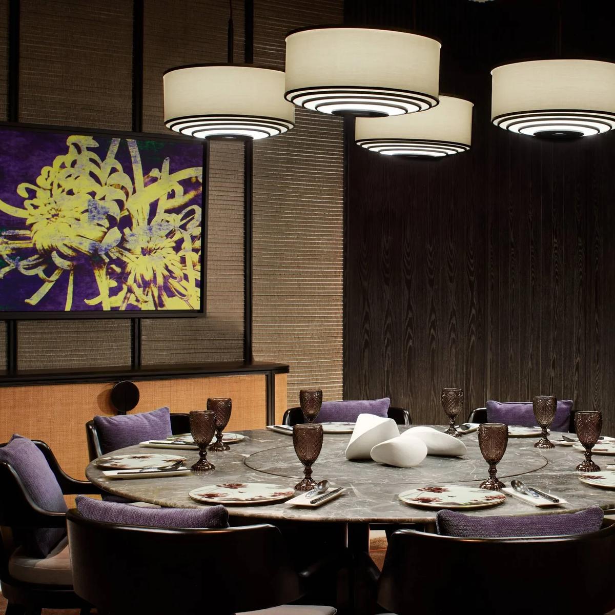 Summer Pavilion's private round dining room, lantern-style pendant lights above a marble table