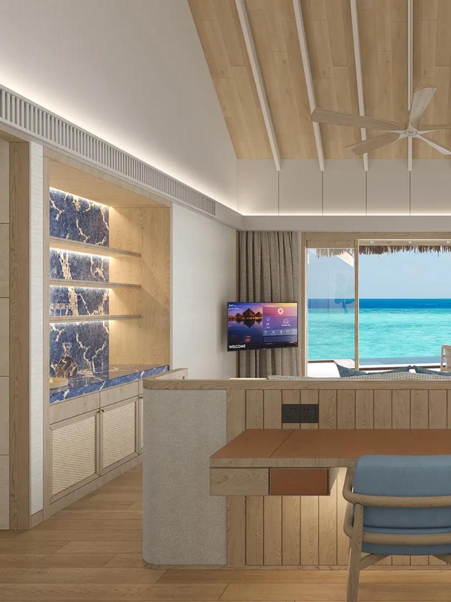 Water Bungalow with Pool living area with a daybed built into the window seat, the lagoon visible through sliding glass doors