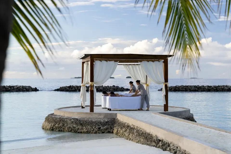 An open-air couples treatment table at LIME Wellbeing, Niva Kurumba's spa