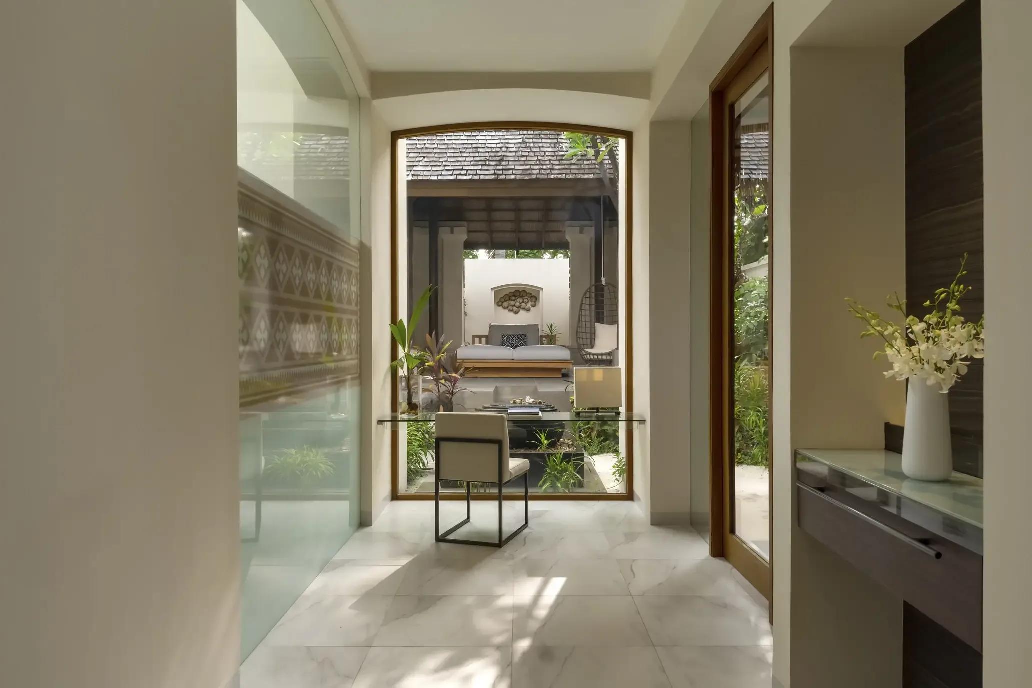 The garden courtyard leading into a Deluxe Beach Villa with Pool at Conrad Maldives Rangali