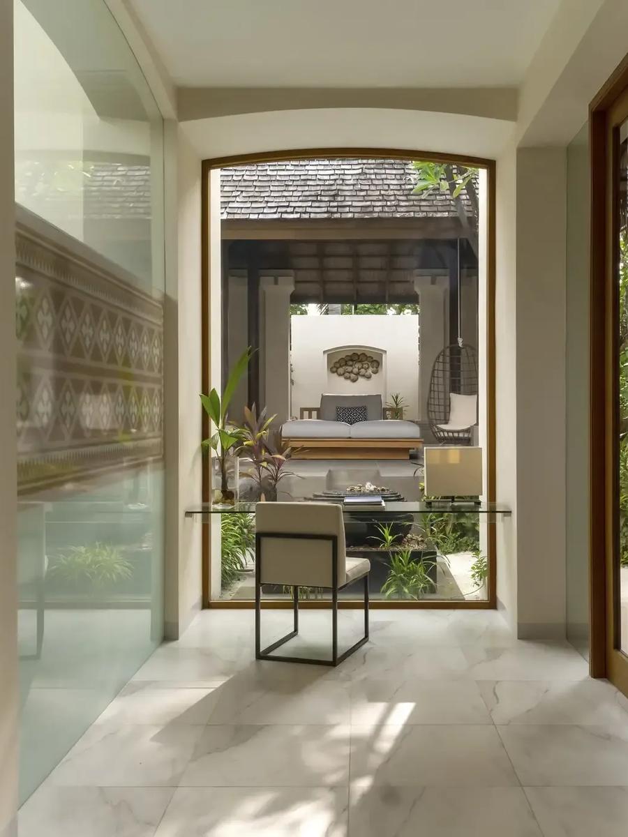 The garden courtyard leading into a Deluxe Beach Villa with Pool at Conrad Maldives Rangali