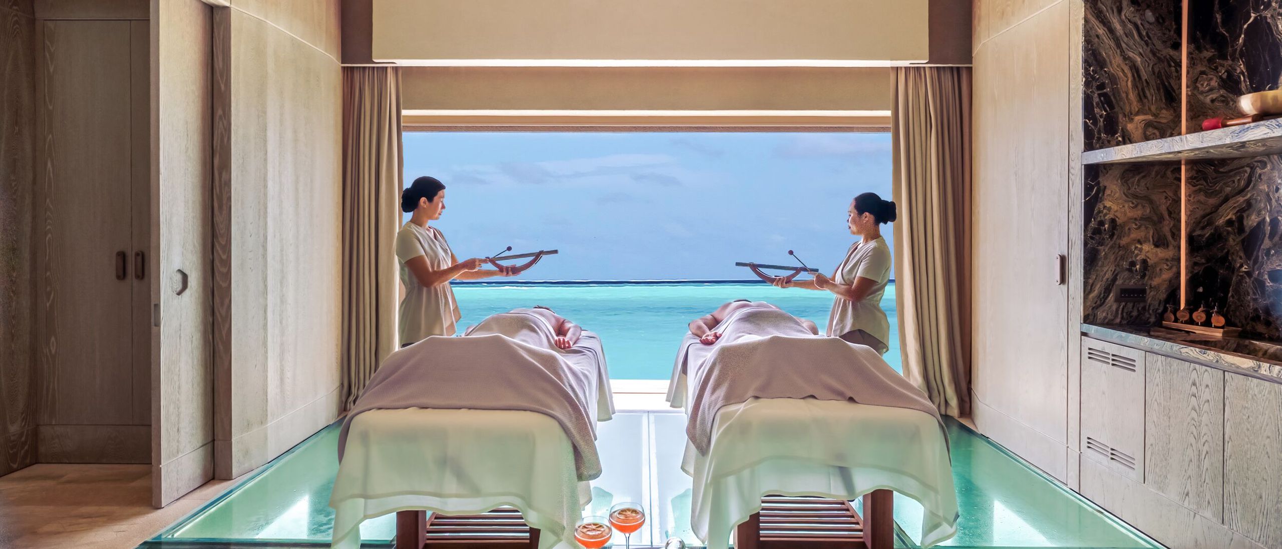 Overwater wellness yoga deck at sunrise at a Maldives wellness resort