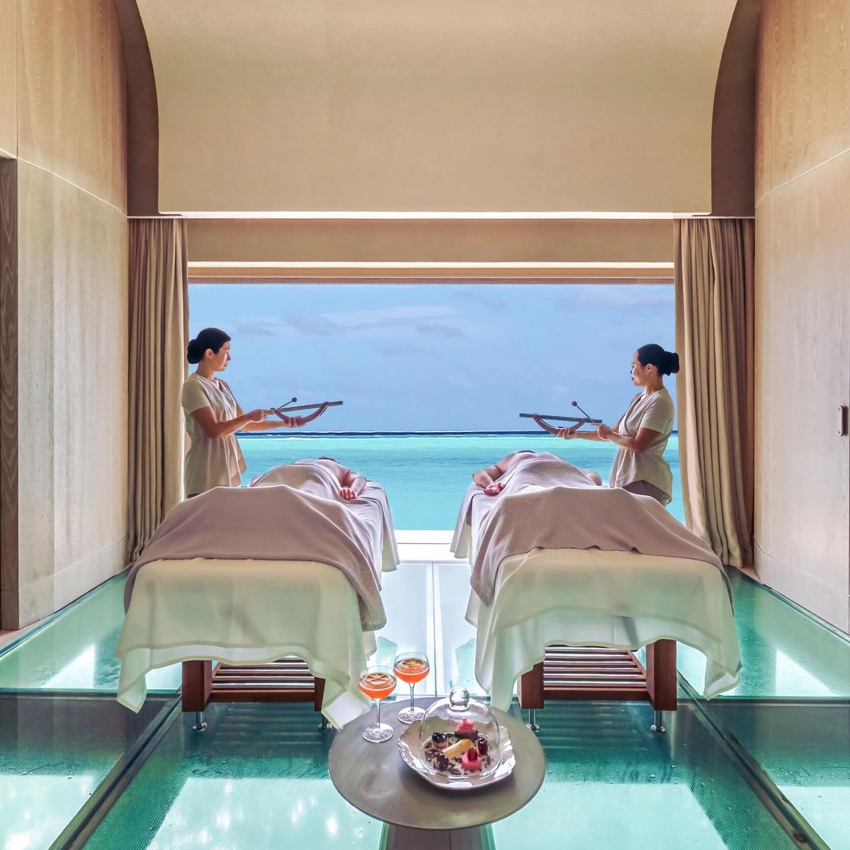 Overwater wellness yoga deck at sunrise at a Maldives wellness resort
