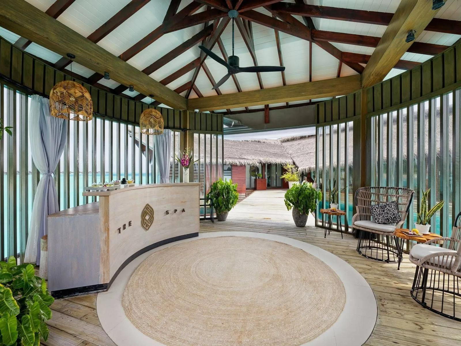 The reception area of The Spa at Grand Park Kodhipparu, with lagoon views