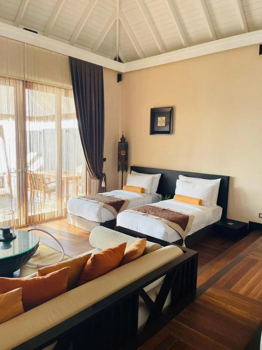 The second bedroom of a Sunset Family Lagoon Suite, two twin beds set apart from the main room
