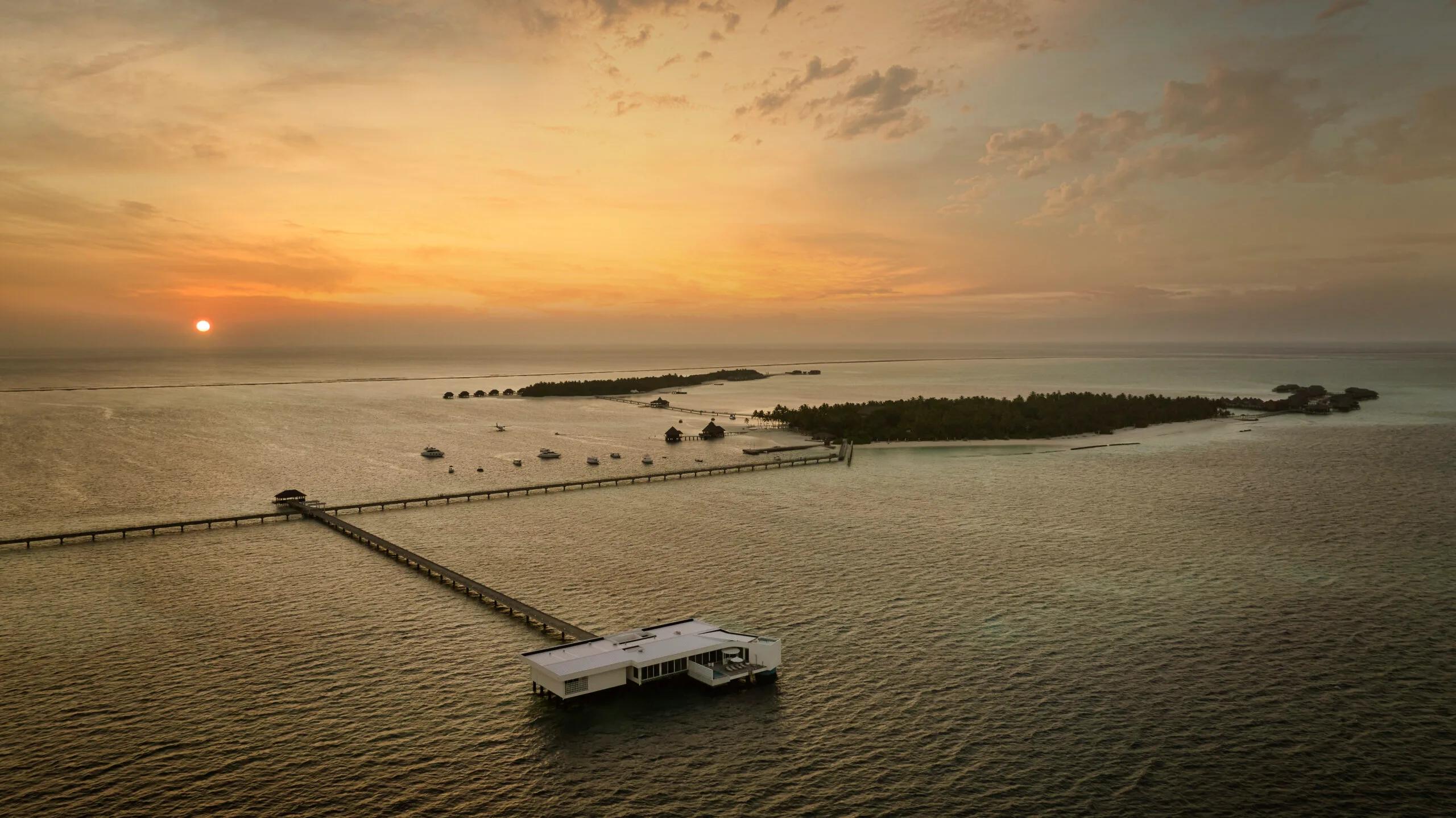 Aerial view of The Muraka at sunset, Conrad Maldives Rangali's undersea residence extending off Rangali Island on its own jetty